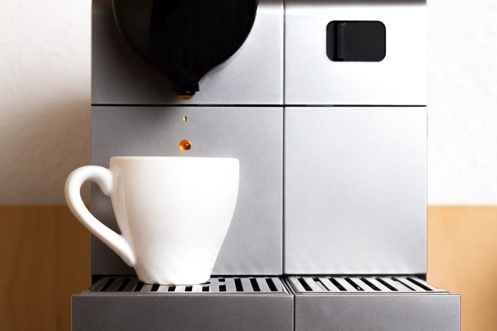 Espresso machine pouring into a white cup