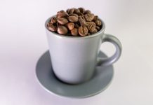 Cup filled with roasted coffee beans